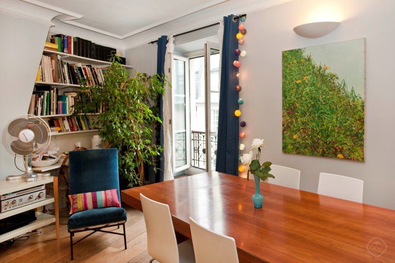 Dining Area with Bookshelves and Wall Artwork Chic Saint Germain apartment Paris