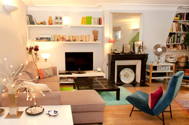 Living Room with Bookshelves and TV Chic Saint Germain apartment Paris